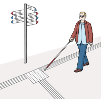 Ein blinder Mensch folgt mit dem Langstock einem Bodenleitsystem auf der Straße